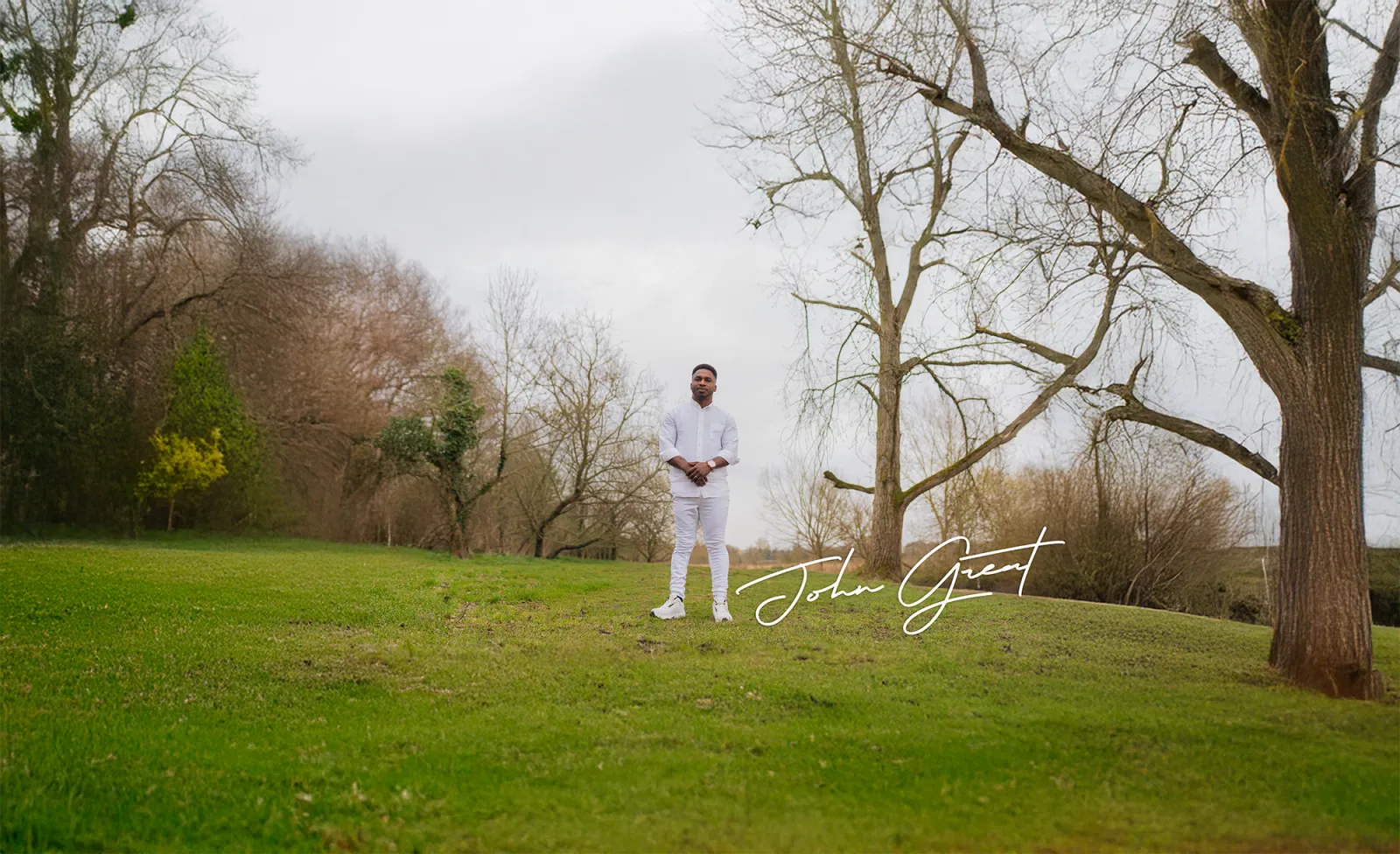 John Great standing in an open landscape